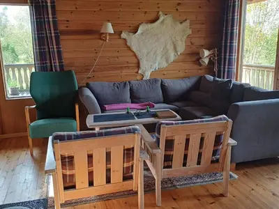 a living room with a couch and a table and chairs at 7 person holiday home in Skjold-By Traum in Skjold