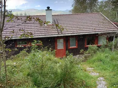 a house with a red door on a hill at 7 person holiday home in Skjold-By Traum in Skjold
