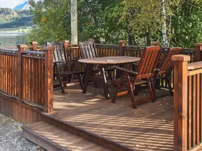 a wooden deck with a wooden table and chairs at 2 person holiday home in Måndalen-By Traum in Sæbø