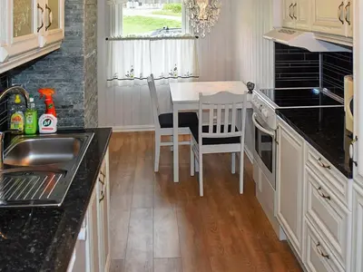 a kitchen with a table and chairs and a sink at 2 person holiday home in Måndalen-By Traum in Sæbø