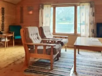a living room with two chairs and a table at 4 person holiday home in Eresfjord-By Traum in Øverås