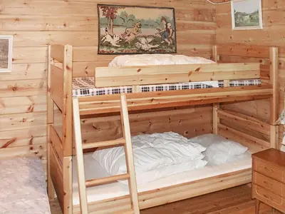 a bedroom with two bunk beds in a log cabin at 5 person holiday home in Brekke-By Traum in Dingja