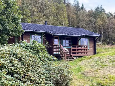 a log cabin on a hill in the woods at 5 person holiday home in Brekke-By Traum in Dingja