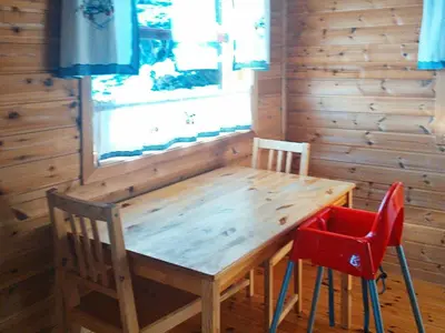 a wooden table and two chairs in a room at 8 person holiday home in Norheimsund-By Traum in Norheimsund
