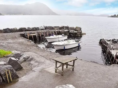 two boats are docked at a dock in the water at 7 person holiday home in Selje-By Traum in Selje