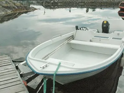 a white boat is docked in the water at 6 person holiday home in Farstad-By Traum in Farstad
