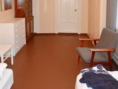 a living room with a wooden floor and a chair at 11 person holiday home in Fjørtoft-By Traum in Fjørtoft