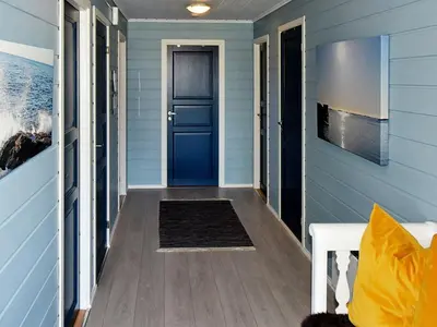 a blue door in a house at 9 person holiday home in Farstad-By Traum in Farstad
