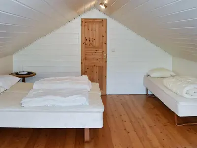 a bedroom with two beds in a attic at 9 person holiday home in Farstad-By Traum in Farstad