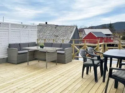 a deck with furniture and a table and chairs at 6 person holiday home in Svelgen-By Traum in Sørgulen