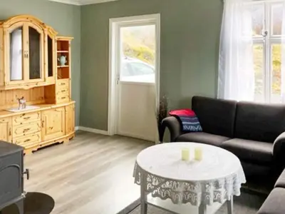 a living room with a couch and a table at 6 person holiday home in Svelgen-By Traum in Sørgulen