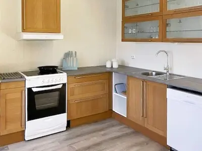 a kitchen with a white stove and a sink at 6 person holiday home in Svelgen-By Traum in Sørgulen