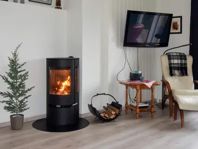 a living room with a fireplace and a tv at 6 person holiday home in Åram-By Traum in Sandvik