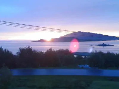 a sunset over a body of water with a mountain at 6 person holiday home in Åram-By Traum in Sandvik
