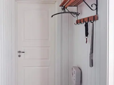 a white door with a knife hanging from it at 6 person holiday home in Storfosna-By Traum in Sletta