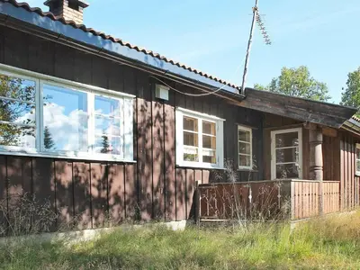 a wooden house with windows on the side of it at 6 person holiday home in NESBYEN-By Traum in Nesbyen
