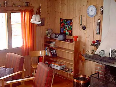 a living room with a fireplace and a clock on the wall at 6 person holiday home in NESBYEN-By Traum in Nesbyen