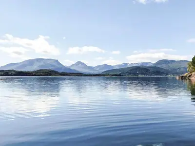 a large body of water with mountains in the background at 9 person holiday home in GURSKØY-By Traum in Kjellsund