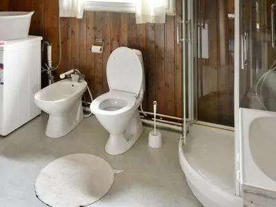 a bathroom with a toilet and a sink and a shower at 4 person holiday home in VÅGLAND-By Traum in Rabben