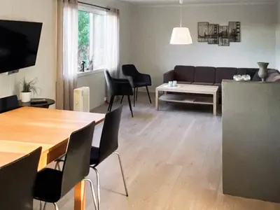 a living room with a couch and a table at 11 person holiday home in VEVANG-By Traum in Vevang