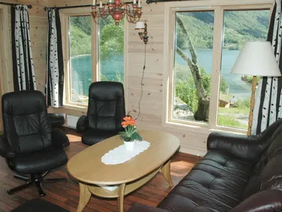 a living room with a table and chairs and windows at 4 person holiday home in olden-By Traum in Olden