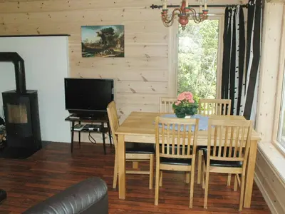 a dining room with a table and chairs and a television at 4 person holiday home in olden-By Traum in Olden