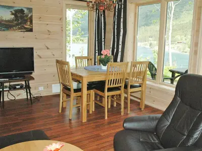 a dining room with a table and chairs and a television at 4 person holiday home in olden-By Traum in Olden