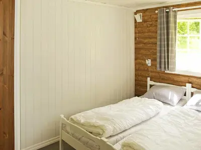 a bedroom with a white bed with a window at 4 person holiday home in Utvik-By Traum in Reed