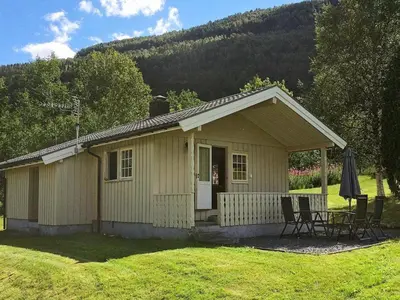 a small house with a table and chairs in a yard at 4 person holiday home in Utvik-By Traum in Reed
