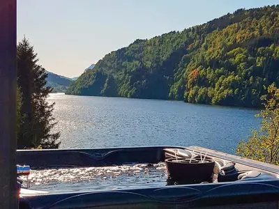 a boat sitting on the shore of a lake at 10 person holiday home in Bygstad-By Traum in Bygstad