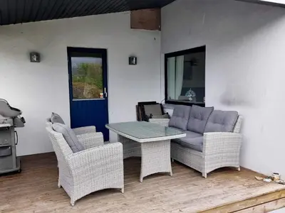 a patio with a couch and chairs and a table at 10 person holiday home in Bygstad-By Traum in Bygstad