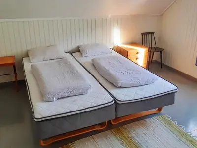 two twin beds in a room with a table at 8 person holiday home in Åfarnes-By Traum in Årset