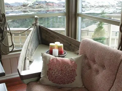 a room with a chair and a window with candles at 8 person holiday home in Kalvåg-By Traum in Kalvåg