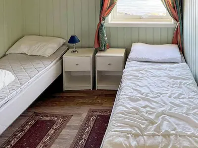 a room with two beds and a window at 6 person holiday home in Storfosna-By Traum in Sletta