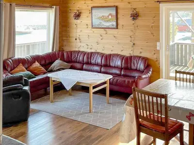 a living room with a couch and a table at 6 person holiday home in Storfosna-By Traum in Sletta