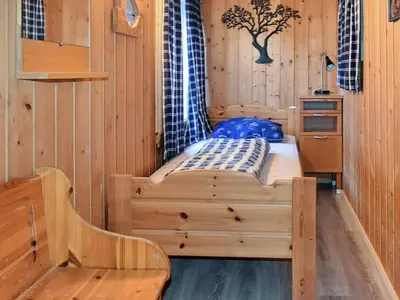 a room with a bed in a wooden cabin at 6 person holiday home in Oksvoll-By Traum in Oksvoll