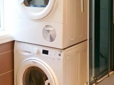 a washer and dryer sitting on top of a washing machine at 6 person holiday home in Gursken-By Traum in Larsnes