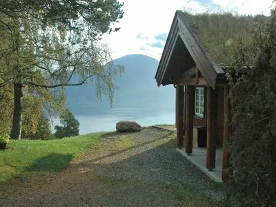 a small building with a view of a mountain at 7 person holiday home in Blaksæter-By Traum in Sølberg