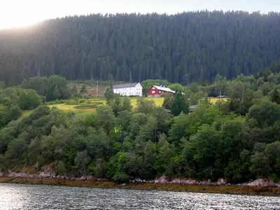 a house on a hill next to a body of water at 10 person holiday home in Follafoss-By Traum in Vølset