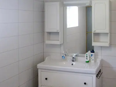 a white bathroom with a sink and a mirror at 10 person holiday home in Follafoss-By Traum in Vølset