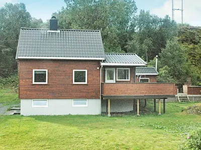a house with a roof on top of a yard at 5 person holiday home in VEVANG-By Traum in Vevang