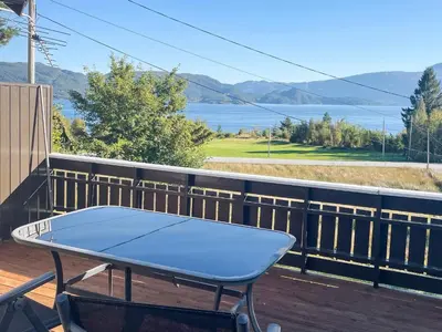 a ping pong table on a deck with a view of the water at 3 person holiday home in Frei-By Traum in Frei