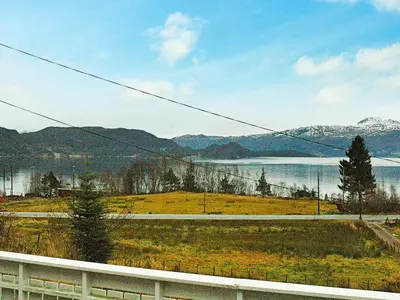 a view of a field with a lake and mountains at 3 person holiday home in Frei-By Traum in Frei