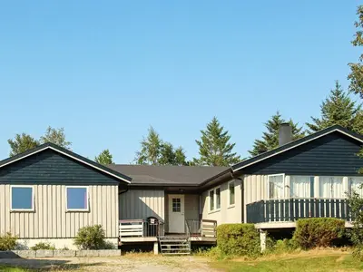 a large house with a black roof at 12 person holiday home in Kvenvær in Kvenvær