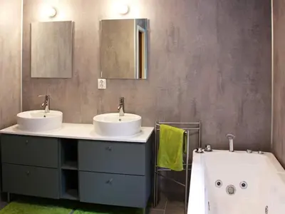 a bathroom with two sinks and a bath tub at 12 person holiday home in Kvenvær in Kvenvær