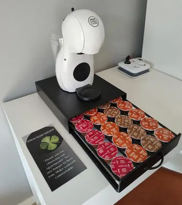a table with a box of cupcakes and a mixer at Oppheim Holiday Apartment in Øyjordi