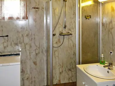 a bathroom with a shower and a sink at 6 person holiday home in Halsanaustan in Korsnes