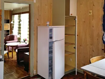 a kitchen with a white refrigerator in a room at 6 person holiday home in Halsanaustan in Korsnes
