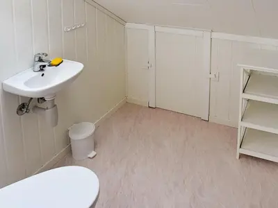 a bathroom with a white sink and a toilet at 10 person holiday home in Bygstad in Bygstad