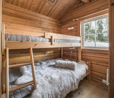 a bedroom with two bunk beds in a log cabin at Trysilfjellet Nord 356 A and B in Trysil